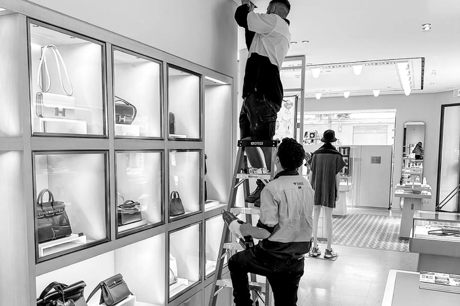 Vogue electricians working on ceiling services in a luxury boutique