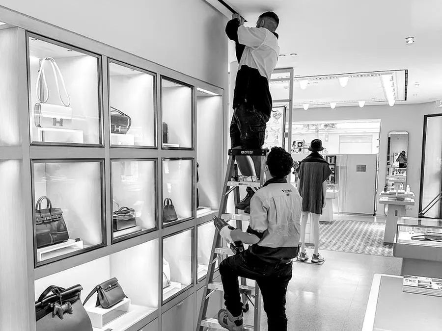Vogue electricians working on ceiling services in a luxury boutique